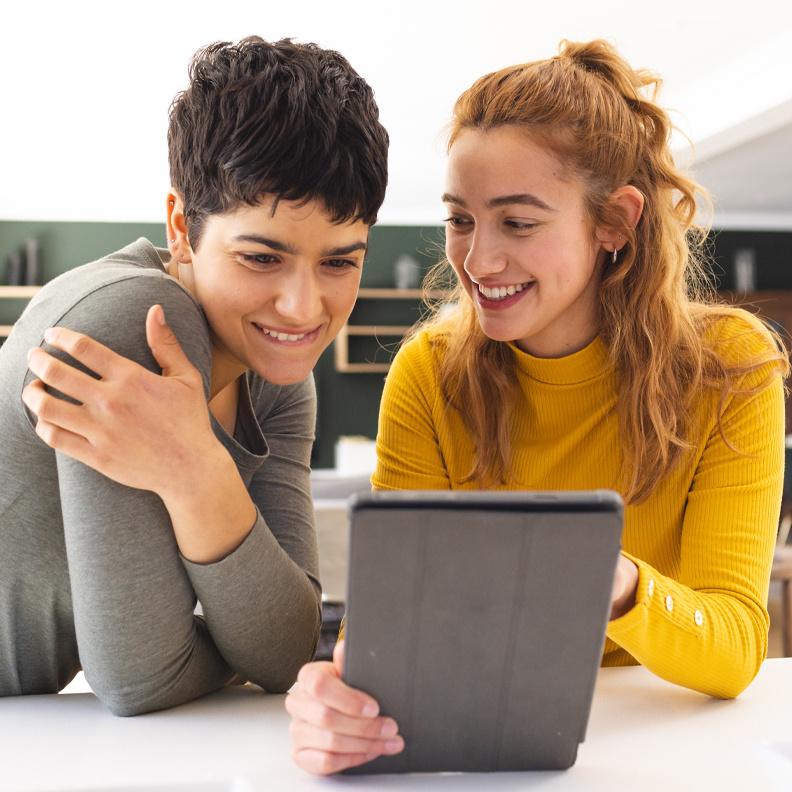 female-couple-looking-at-tablet