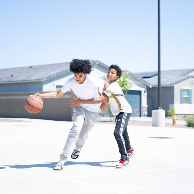 Kid and teen playing basketball